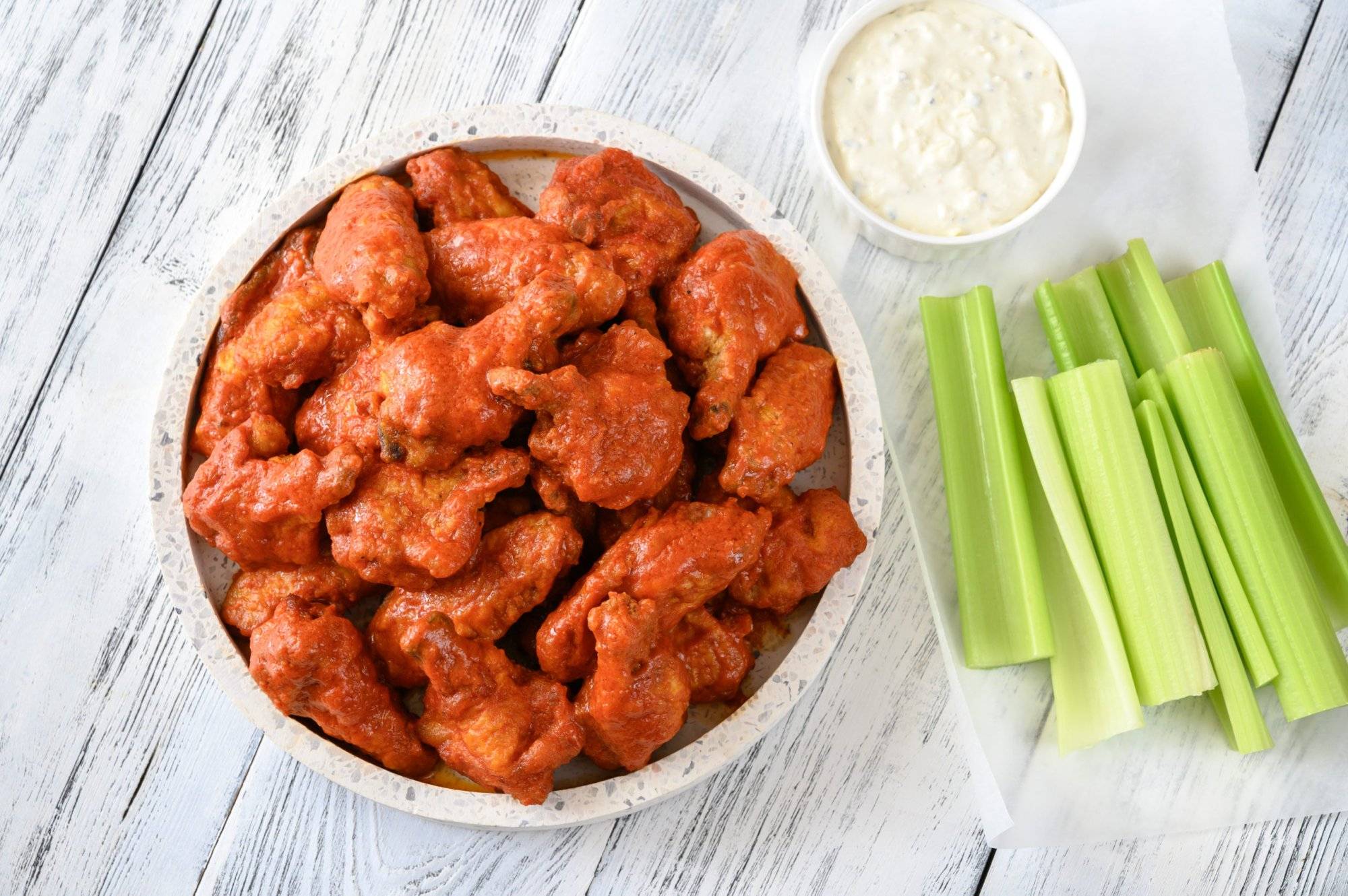 Bowl of buffalo wings with blue cheese dip