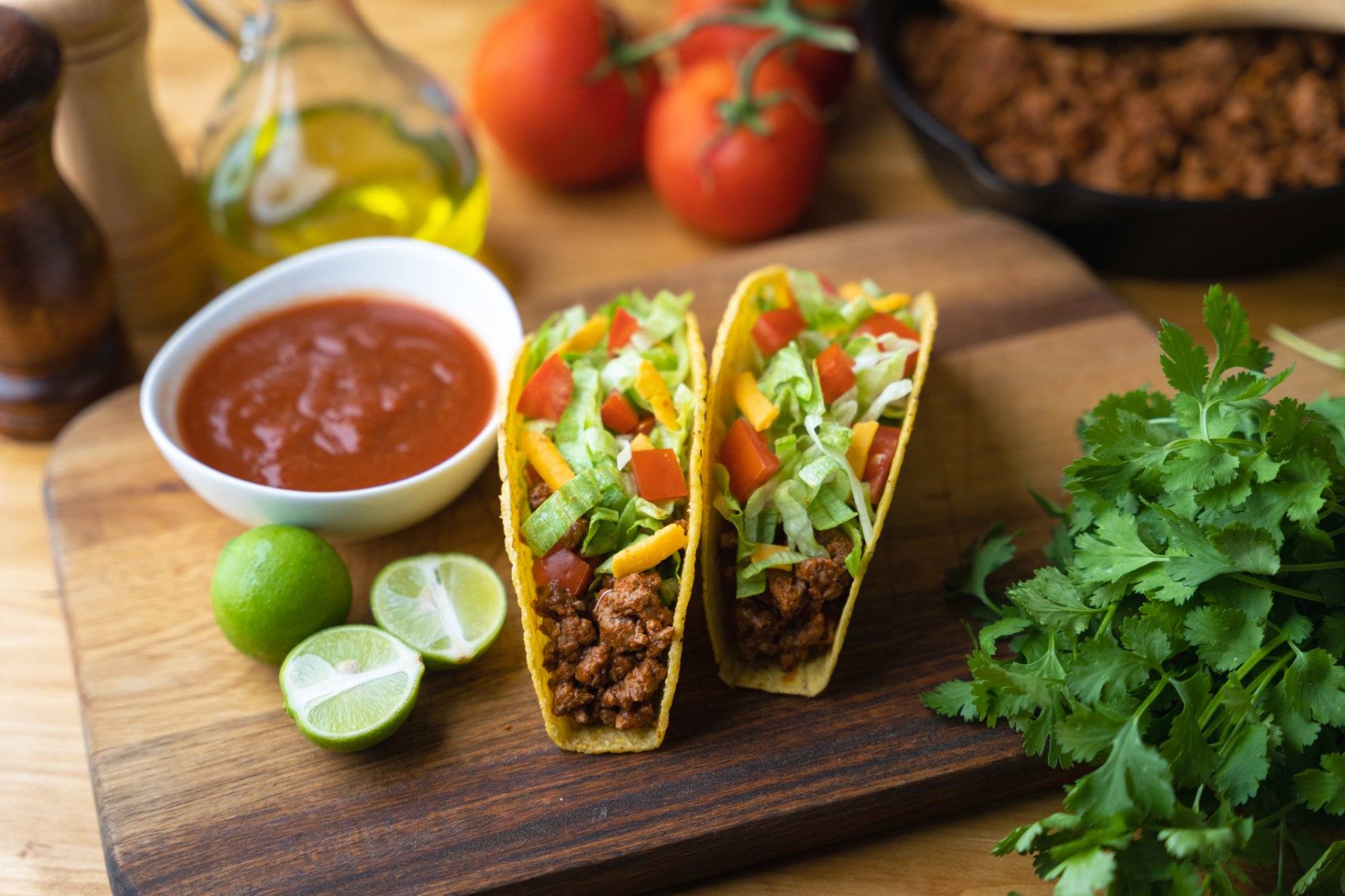 hard shell taco on wooden board with lime hard shell taco on wooden board with lime