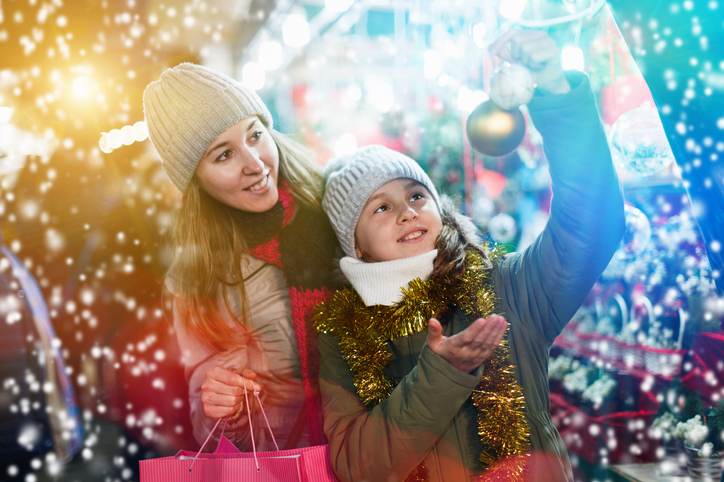 Woman and her daughter are preparing for Christmas and choosing